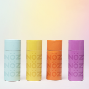 Front view of Noz sunscreen bottles in blue, yellow, orange, and purple